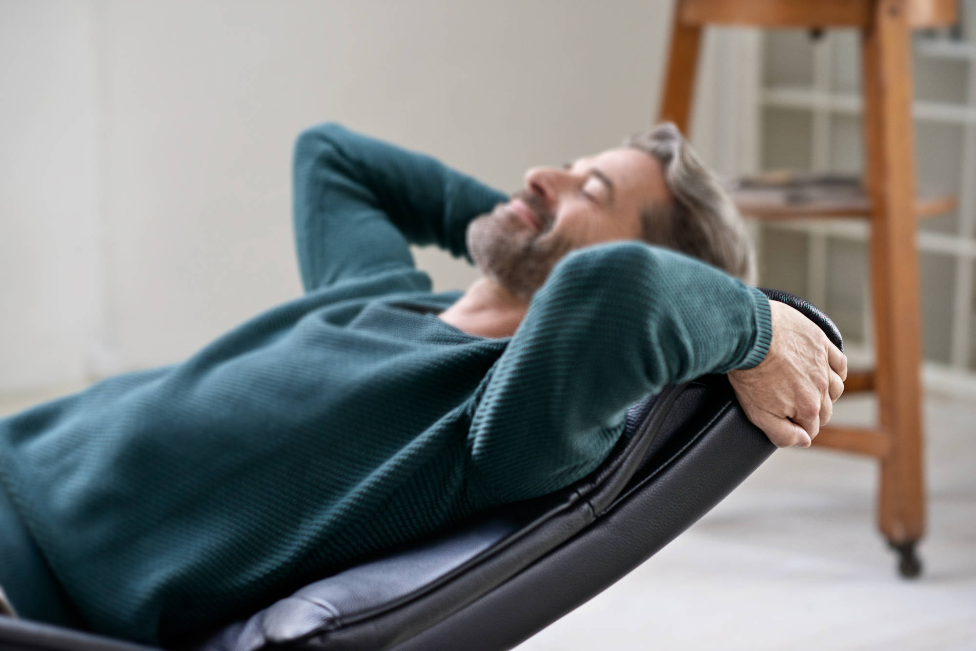 man leaning back into Stressless Recliner Headrest