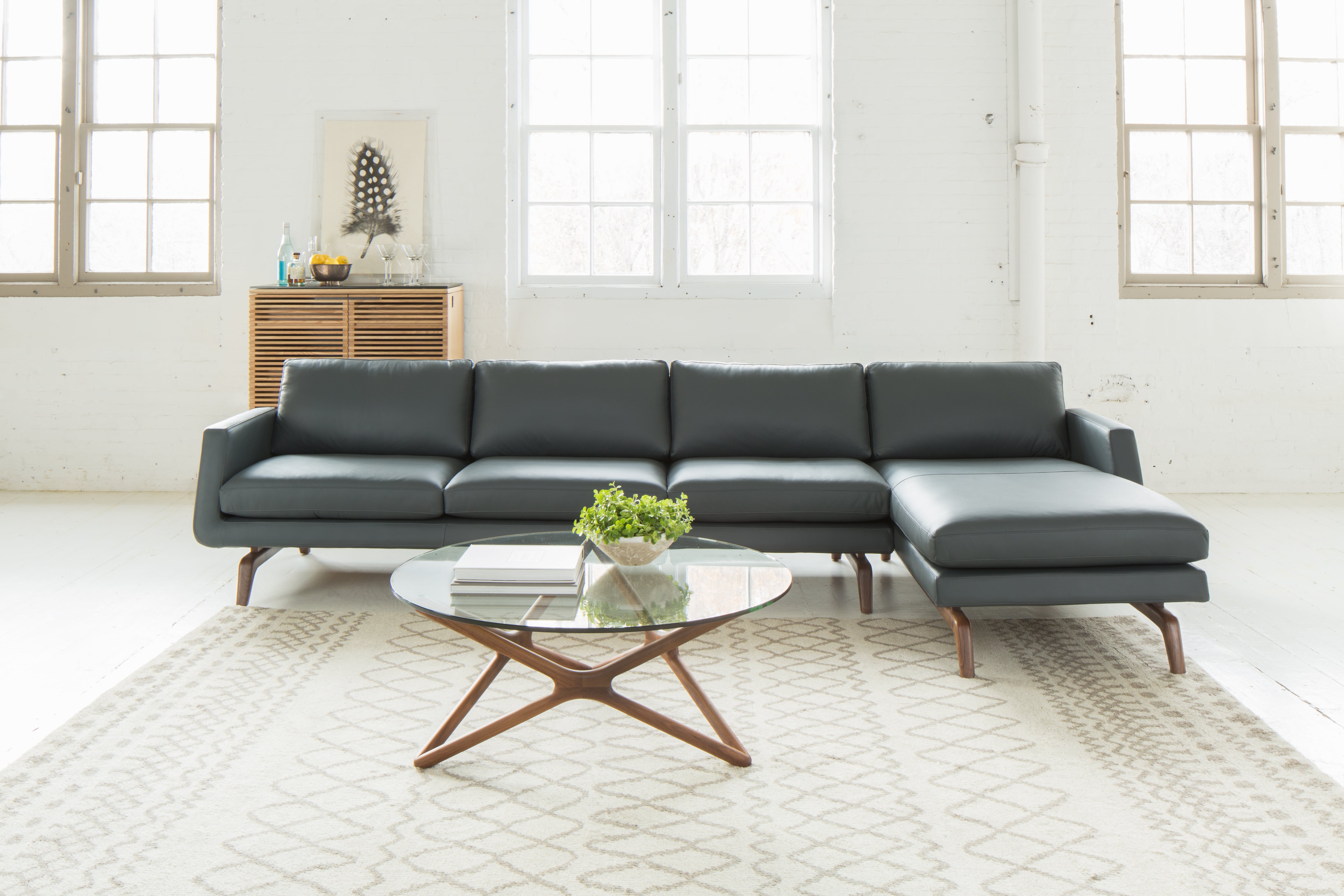 gray leather couch paired with an off-white area rug with a light gray zigzag pattern