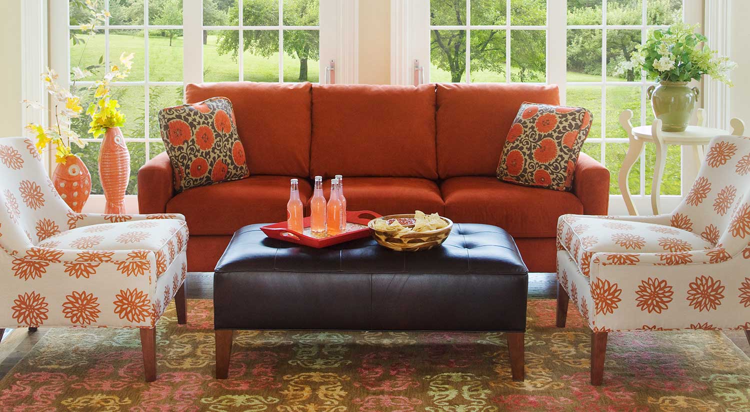 living room with orange couch and matching decor