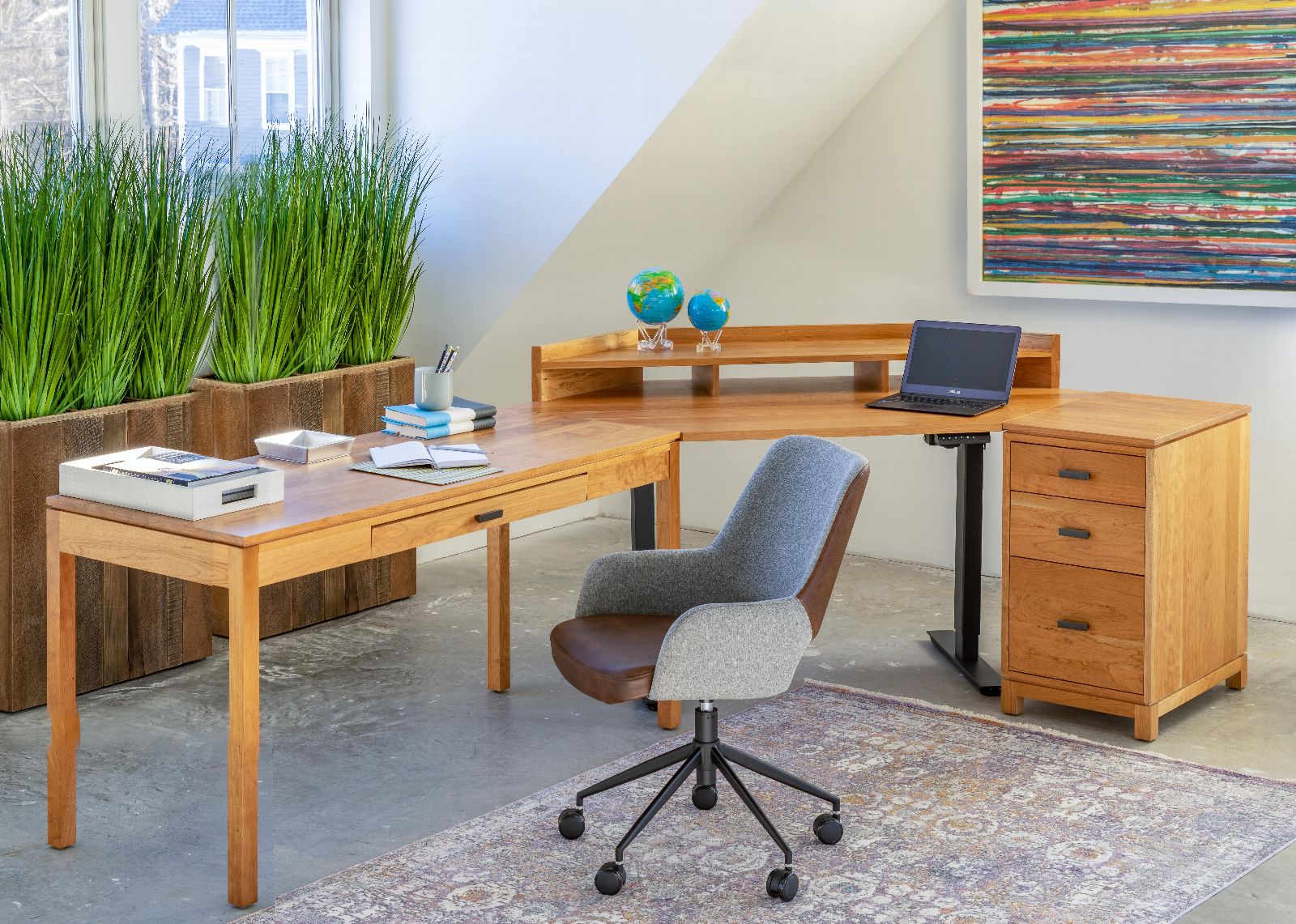 modern wooden desk in front of window with greenery 