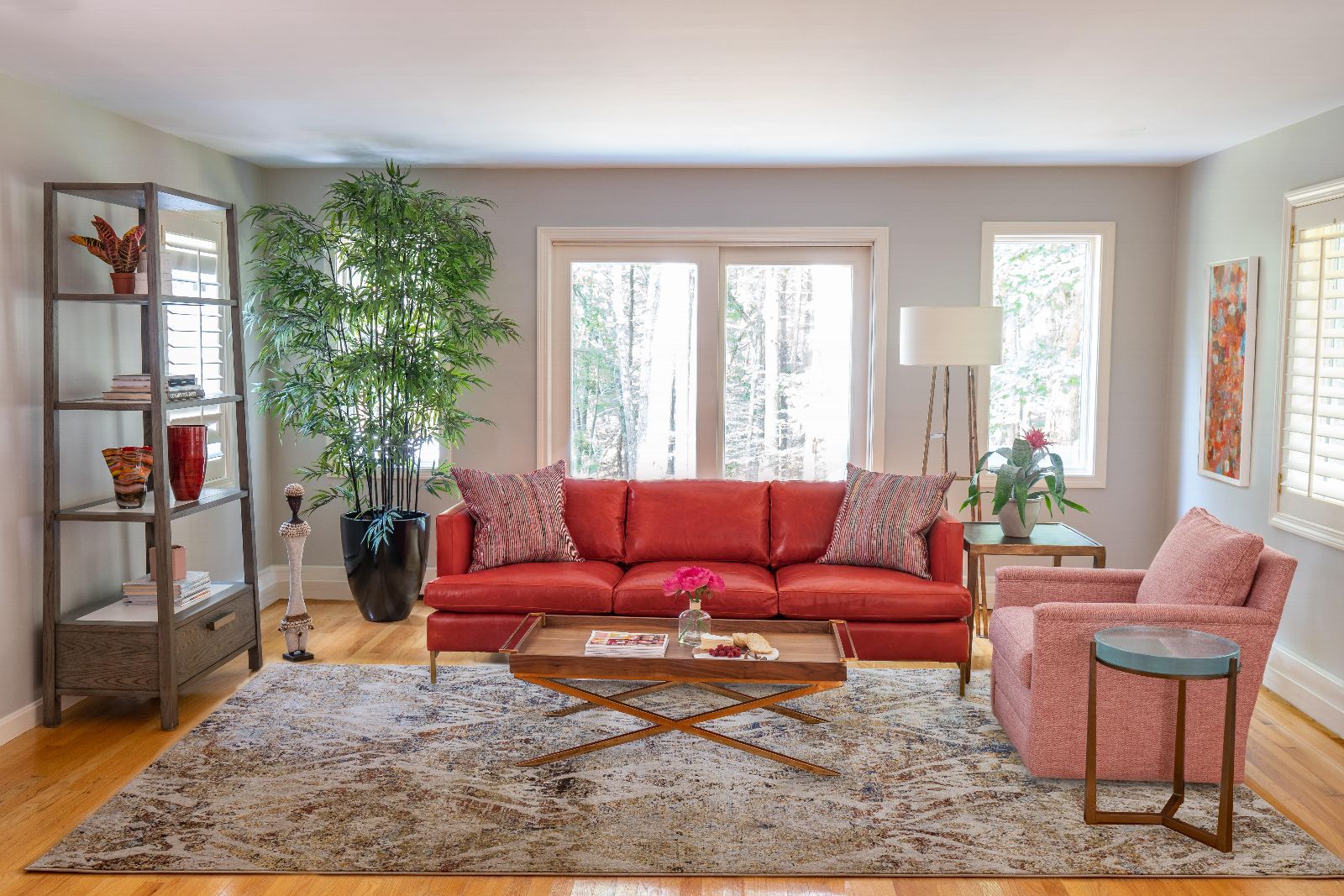 living room with red couch and potted bamboo