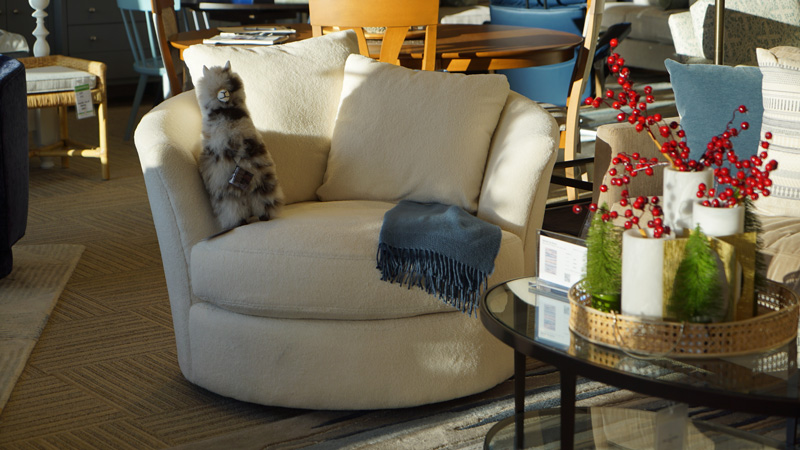 accent chair with blue throw blanket and stuffed llama